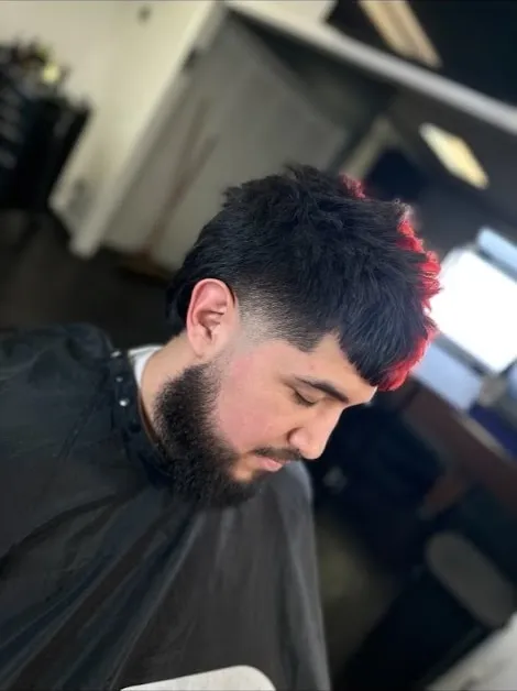 A textured crop with a red color streak through the front, paired with a full shaped beard
