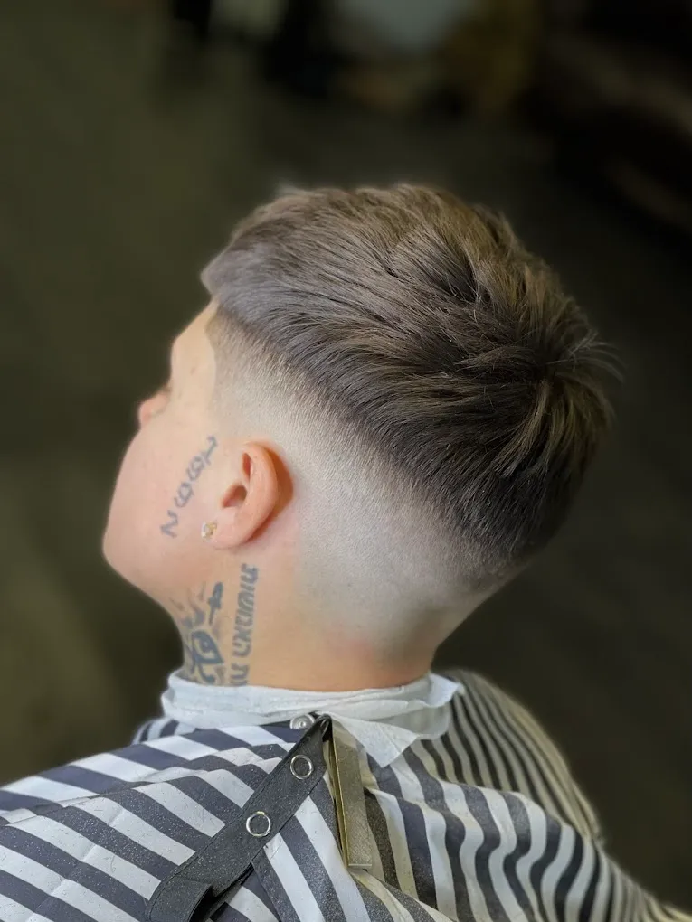 Back view of a textured drop fade, blended from a skin fade at the neckline up into a longer, piecey top